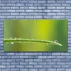 tulup.si Slika na steklu Dew drop na travi 140x70 cm 2 obešalnika