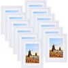 Nikcorp Komplet okvirjev Spotjoy 12 kosov 13x18 cm beli, MDF okvir, akrilno steklo, z passe-partout in brez, za fotografije 9x13 ali 13x18 cm, navpična in vodoravna namestitev