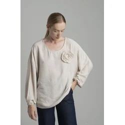 Beige oversize blouse with a decorative flower