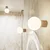 Sivorjava stenska svetilka Orbital – Nice Lamps
